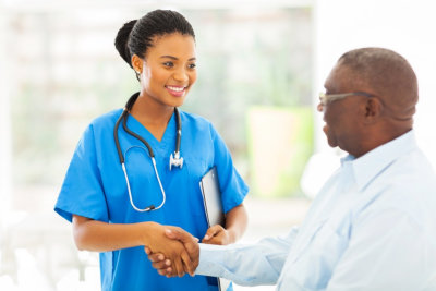 nurse handshaking with senior patient